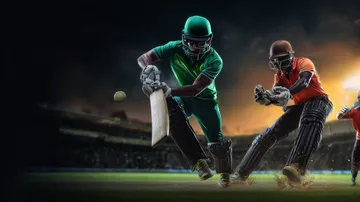 A man celebrating a winning moment on his laptop while gaming symbols float around him, capturing the excitement of BAJI200 games.